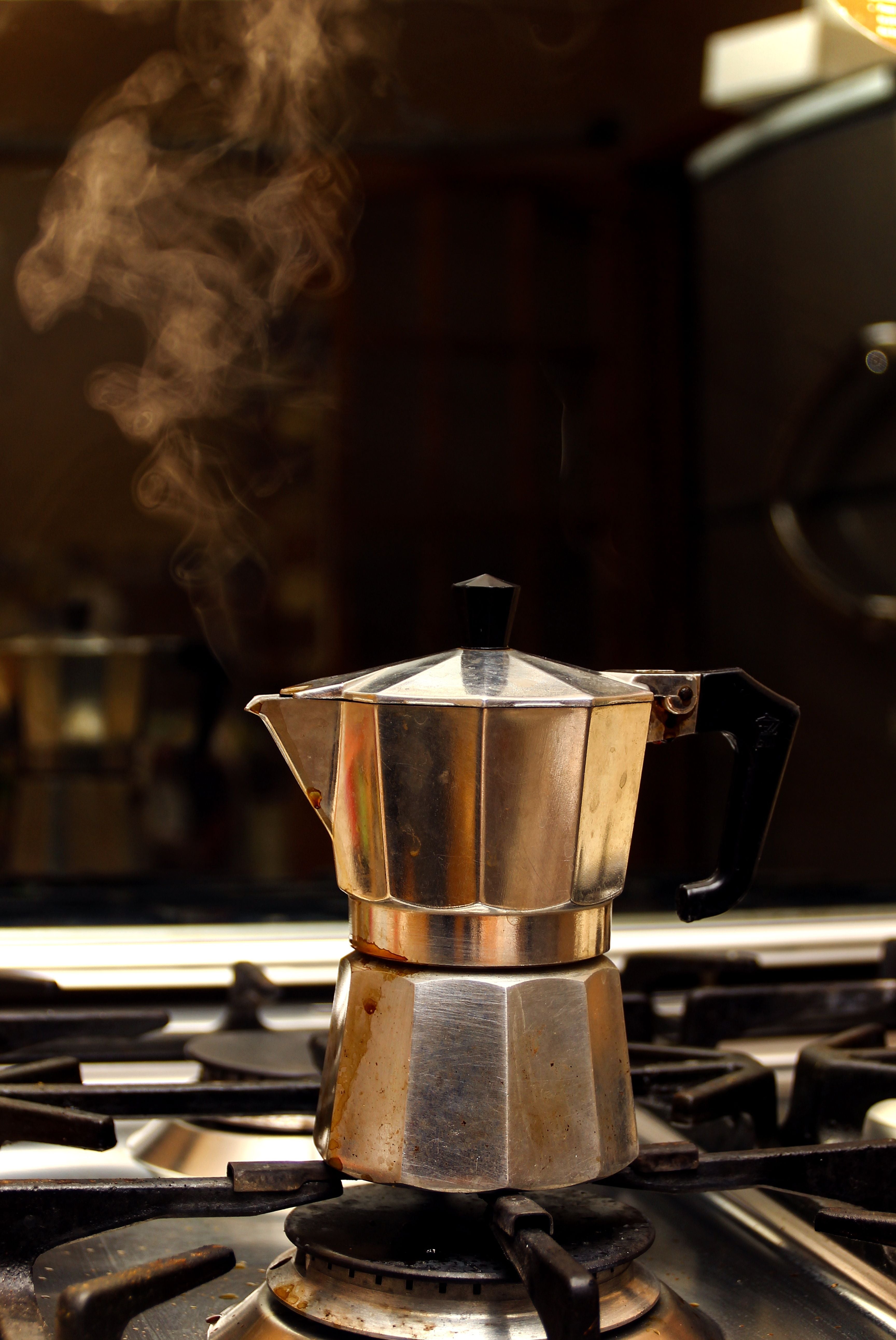 Steaming moka pot brewing on a stovetop